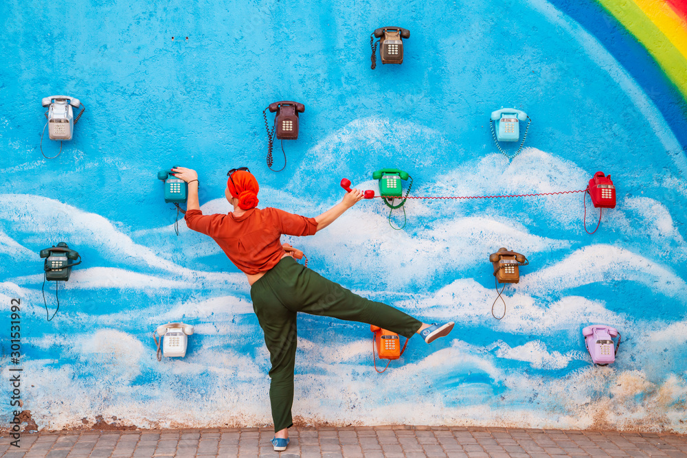 Obraz premium Girl talking on an old fashioned phone. Communication concept.