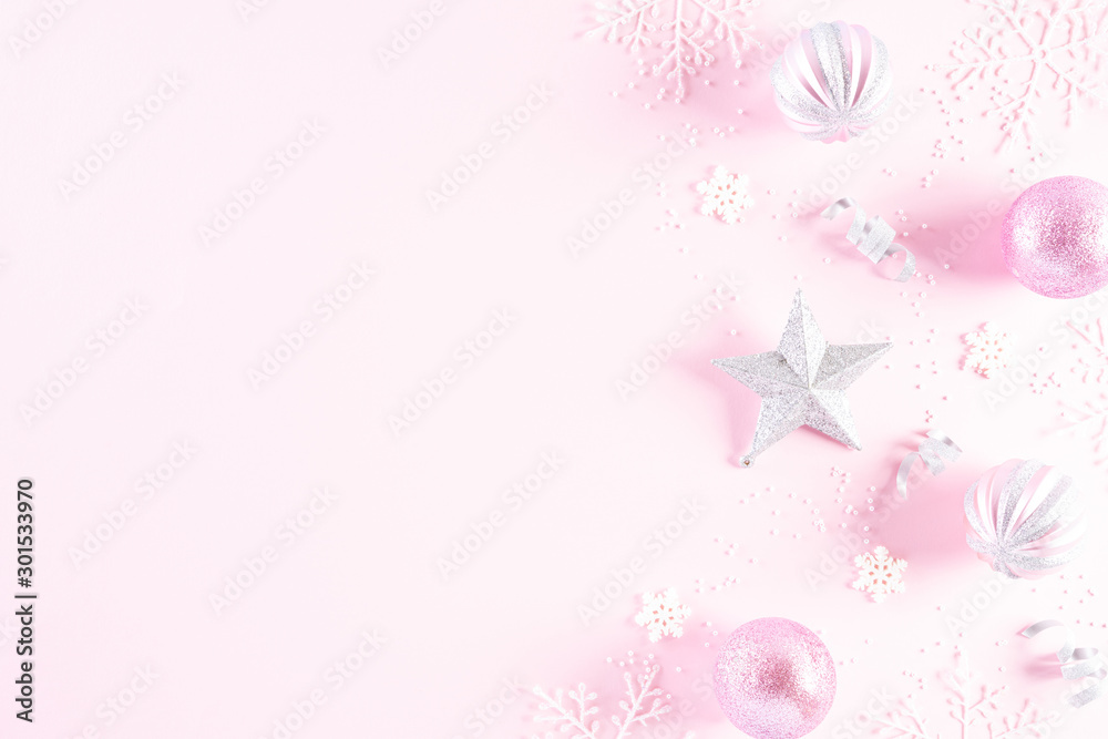 Christmas background concept. Top view of Christmas ball with snowflakes on light pink pastel background. Christmas background concept. Top view of Christmas ball with snowflakes on light pink pastel background.