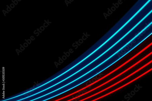 Red and blue light dynamics lines on a black background .