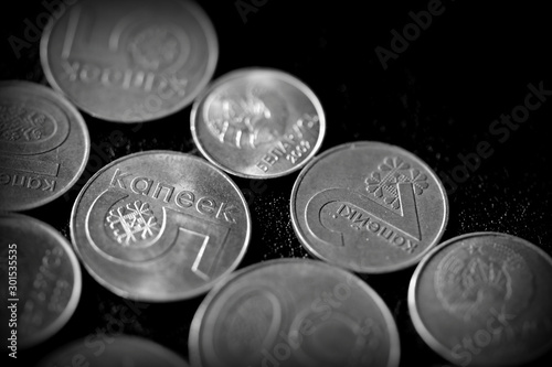 Belarusian coins scattered on a dark surface close up. Monochrome money background