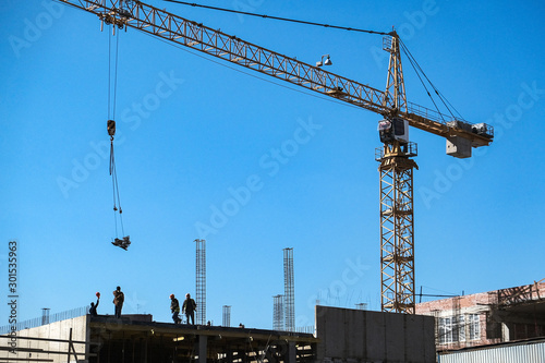 the high crane at a construction site