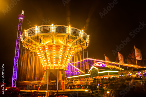 Helsinki, Finland - 19 October 2019: The Carnival of Light event at the Linnanmaki amusement park. Ride chain carousel Ketjukaruselli in night illumination.