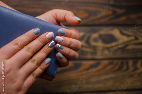 Women s hands with colorful pattern on the nails. Top view. Place for text. cozy winter style.