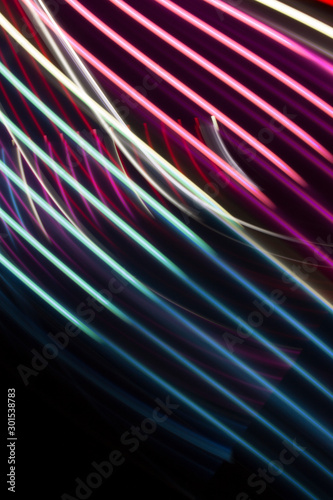 Pink and blue light curve lines on a black background .