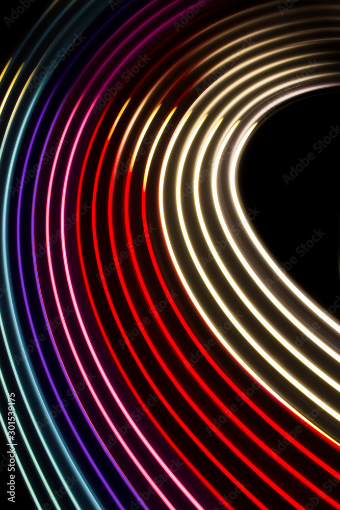 Fototapeta premium Red, magenta and blue light curve lines on a black background .