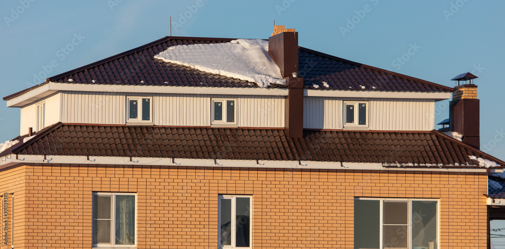 Brick house with snow on the roof