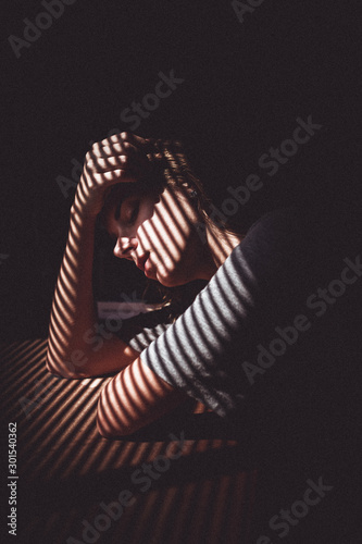 Pensive woman in shadow © Lais