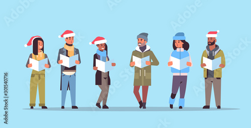 Mix race people reading books merry Christmas
