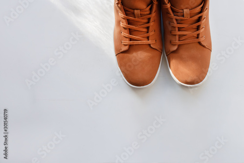 Brown winter sneakers on a white background, close-up, copyspase