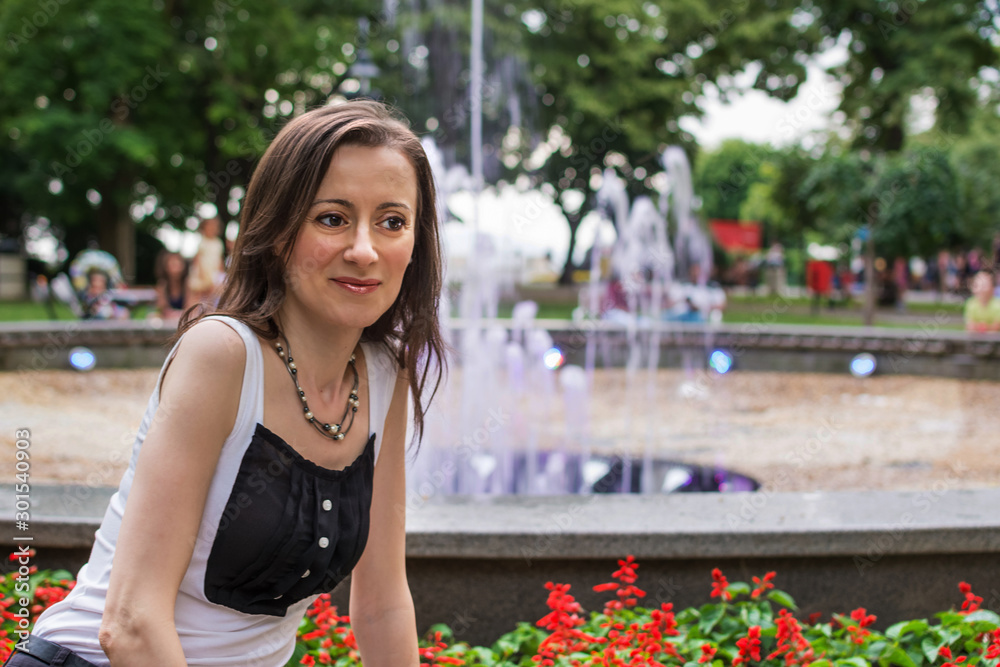 Tourist takes a souvenir photo in front of the Burgas fountain, Bulgaria Tourist takes a souvenir photo in front of the Burgas fountain, Bulgaria
