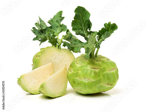 Fresh kohlrabi with green leaves on isolated white backround