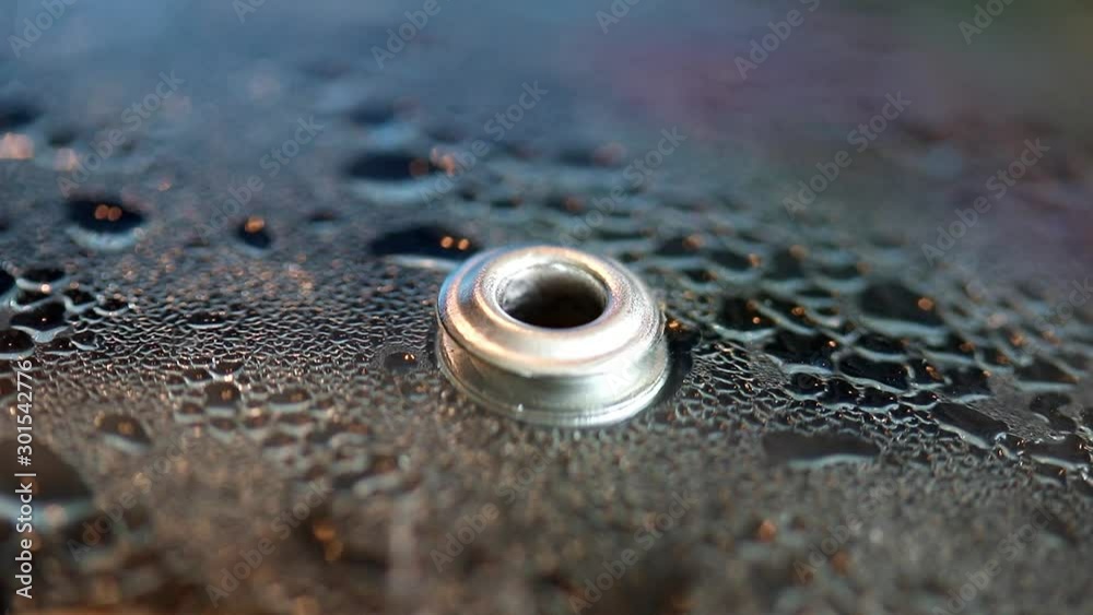 Pressure cup lid with overpressure fuse. Macro view of a pot lid with a hole for steam. The detailed look at process of pressure cooker. Pressure cup lid with overpressure fuse. Macro view of a pot lid with a hole for steam. The detailed look at process of pressure cooker.