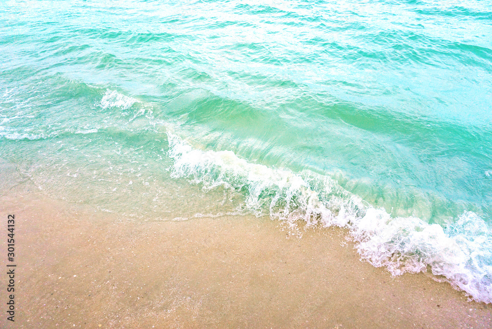 The light wave and beautiful green sea with space for texts on the beach background..