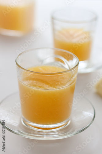 Two glasses of refreshing orange juice on a white table