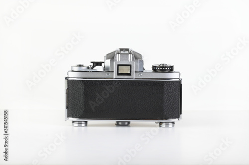 The old German 35 mm SLR film camera with lens 50 mm lens on a white background. photo