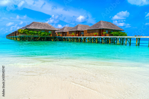 Wooden bridges leading to the huts on the shores of the tropical