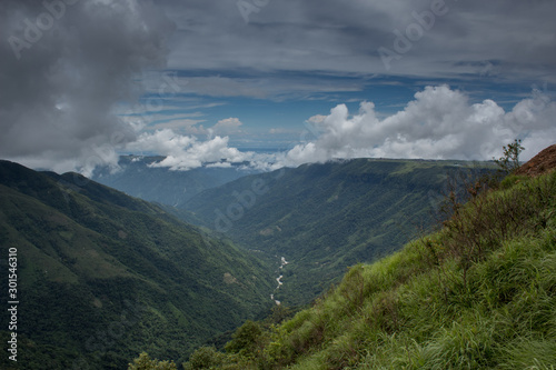 River course between hills covered with dense clouds in Meghalaya, India