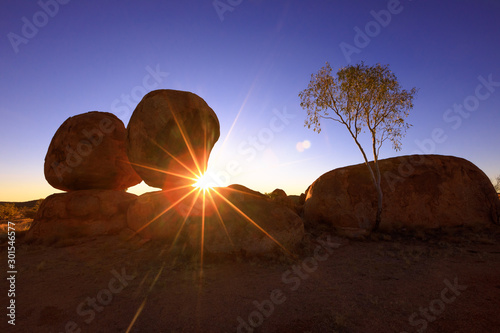 Devils Marbles: the Eggs of mythical Rainbow Serpent at Karlu Karlu - Devils Marbles Conservation Reserve. Twilight sky over Australian Outback landscape in Northern Territory, Red Centre.