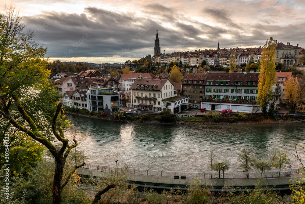 Fototapeta premium Panoramic view of the Bern old town with the Aare river flowing around the town at sunset in Bern, Switzerland