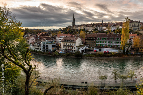 Panoramic view of the Bern old town with the Aare river flowing around the town at sunset in Bern, Switzerland