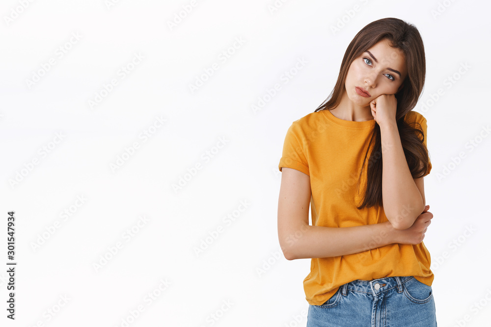 Bored, unamused and reluctant good-looking young stylish woman in yellow t-shirt, facepalm, lean on fist and look with apathy, feeling boredod, standing with sad unimpressed expression Bored, unamused and reluctant good-looking young stylish woman in yellow t-shirt, facepalm, lean on fist and look with apathy, feeling boredod, standing with sad unimpressed expression
