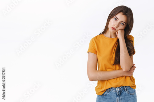 Photography Bored, unamused and reluctant good-looking young stylish woman in yellow t-shirt
