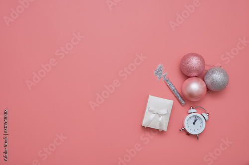 Top view of pink background with balls and gist box. Present for christmas or new year. copy space