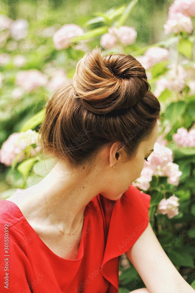 Young pretty girl's portrait on parkland background