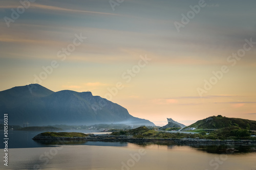 Golden sunlight on bridge of Atlantic Road Norway ocean view