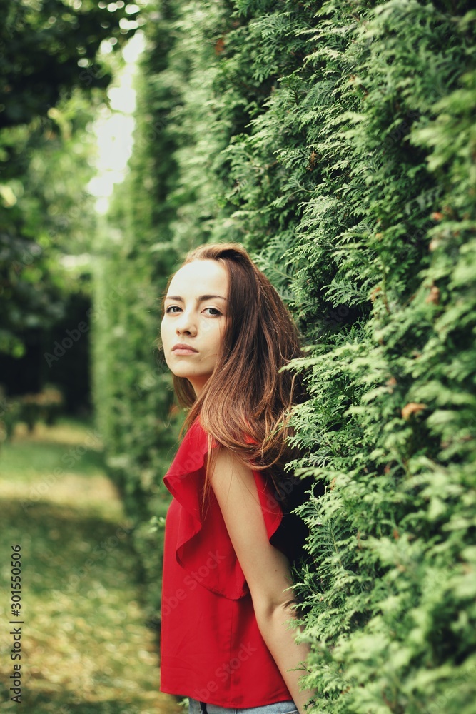 Young pretty girl's portrait on parkland background Young pretty girl's portrait on parkland background