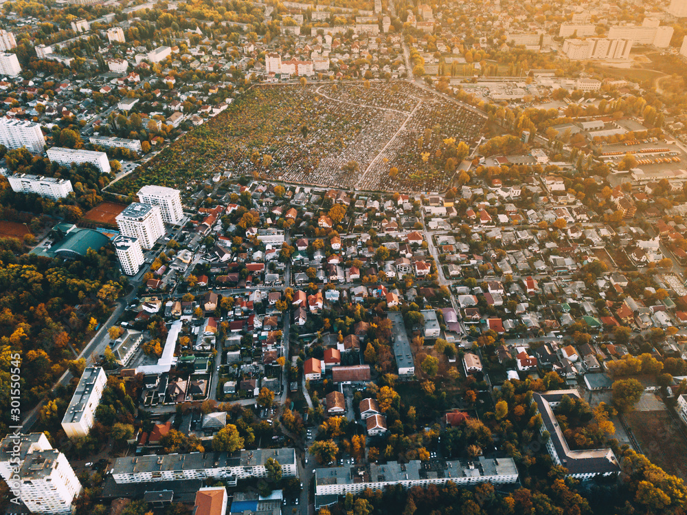 Naklejka premium Amazing view from drone above green beautiful city at sunset