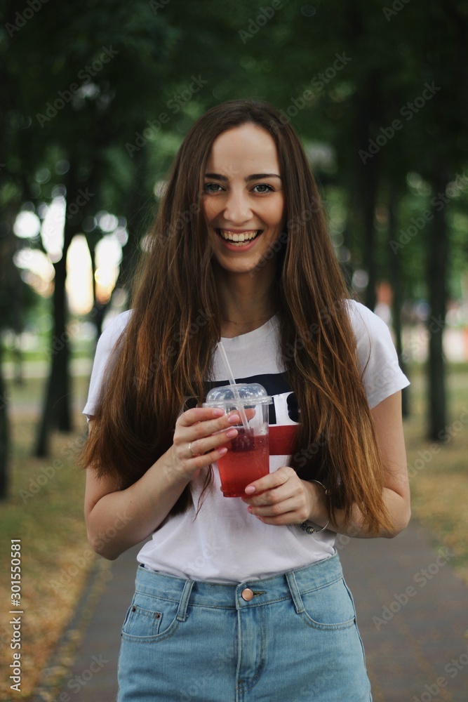 Young pretty girl walking down the street