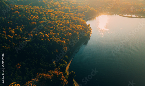 Aerial drone shot of beautiful landscape with lake in park, cityscape, blurry image photo