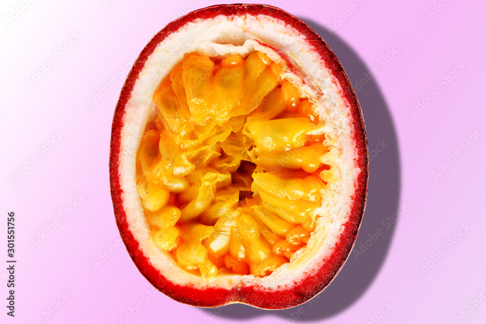 Passion fruit half with shadow isolated on pink gradient background. Top view. Passion fruit half with shadow isolated on pink gradient background. Top view.