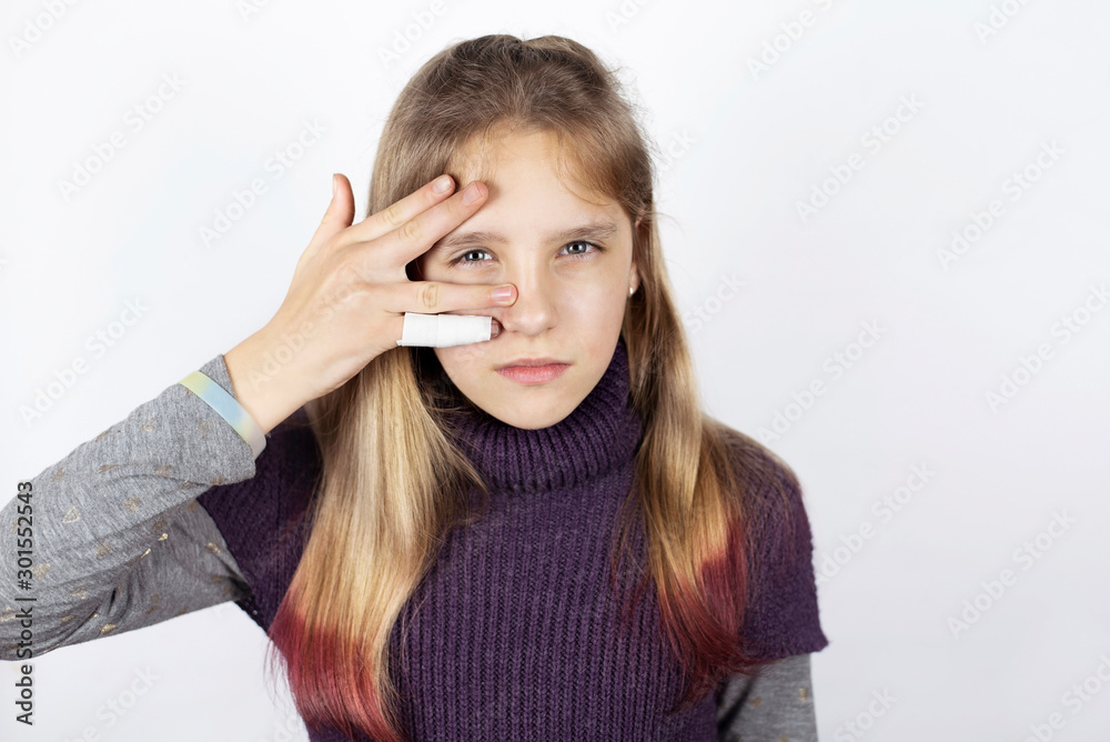 Young girl with damaged finger with plaster and bandage. Girl sad because with a broken finger she can't play the piano and perform at the concert Young girl with damaged finger with plaster and bandage. Girl sad because with a broken finger she can't play the piano and perform at the concert