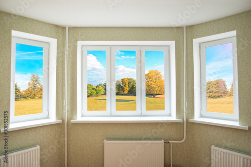 View through a modern PVC window onto beautiful autumn landscape