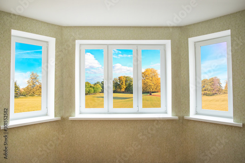 View through a modern PVC window onto beautiful autumn landscape photo