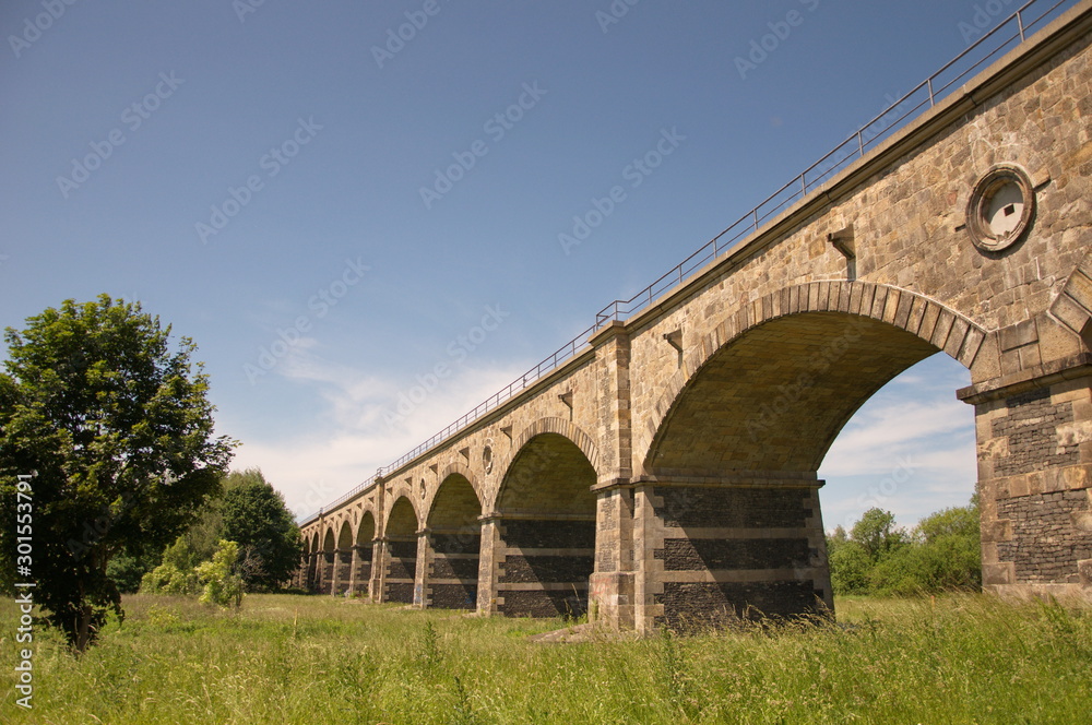 Stone railway bridge over the river on the border between Poland and Germany.