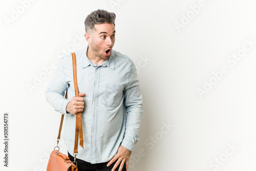 Young handsome business man being shocked because of something she has seen.