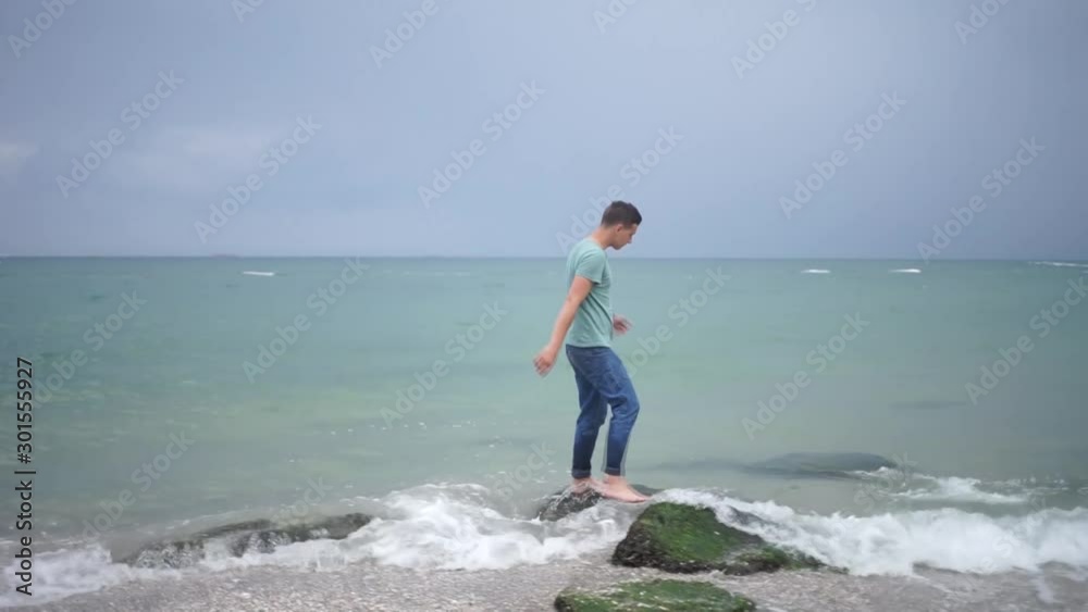 Beautiful man walking on the beach.Beautiful men happy relax walking on beach near sea. Lifestyle men travel on beach concept. Beautiful man walking on the beach.Beautiful men happy relax walking on beach near sea. Lifestyle men travel on beach concept.