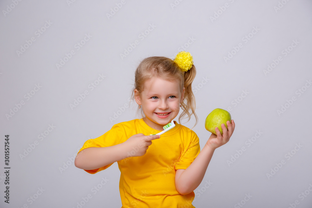 girl the blonde on a yellow background with a toothbrush girl the blonde on a yellow background with a toothbrush