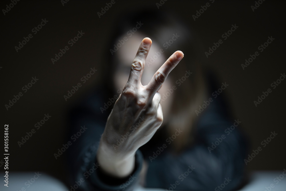 portrait of a woman doing victory sign