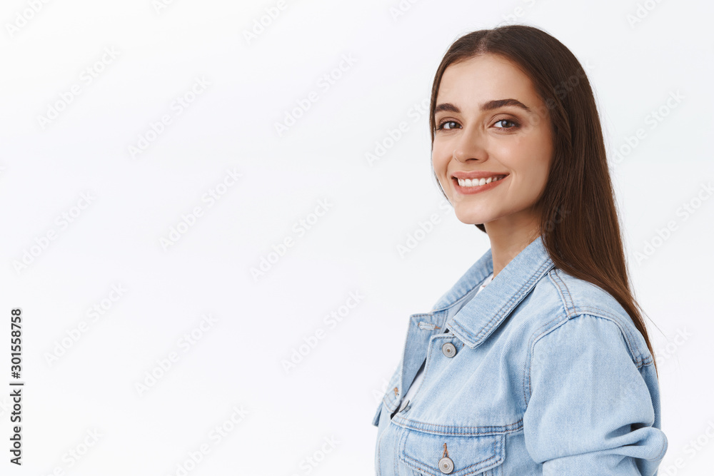 Close-up portrait, tender charming 20s girl with nude makeup and long hair, wear denim jacket, turn to camera, smiling satisfied with happy, relaxed expression, standing white background Close-up portrait, tender charming 20s girl with nude makeup and long hair, wear denim jacket, turn to camera, smiling satisfied with happy, relaxed expression, standing white background