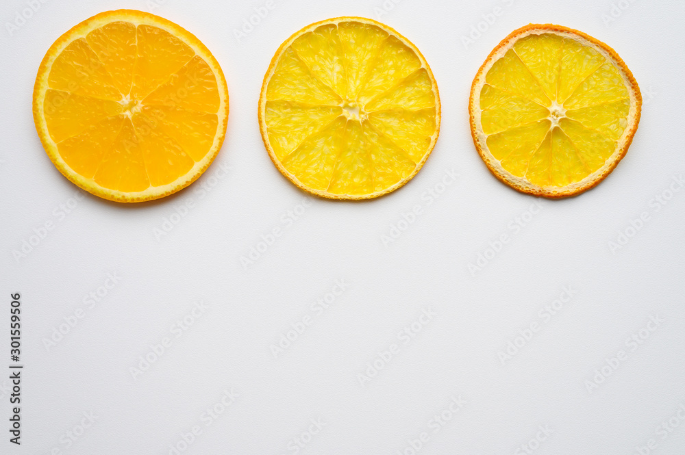 fruit pattern of three orange slices in fresh, dried and dry form on a white background. concept of withering and aging fruit pattern of three orange slices in fresh, dried and dry form on a white background. concept of withering and aging
