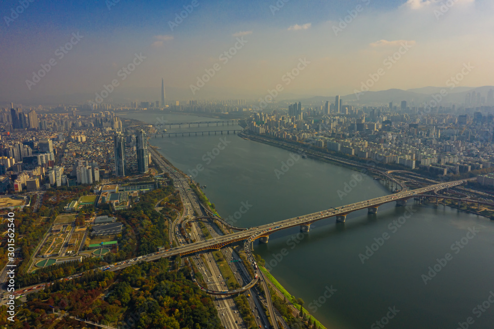 Aerial view of Seoul downtown city skyline with vehicle on expressway and bridge cross over Han river in Seoul city, South Korea.