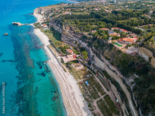 Aerial view of the Calabrian coast, villas and resorts on the cliff. Transparent sea and wild coast. Locality of Riaci near Tropea, Calabria. Italy