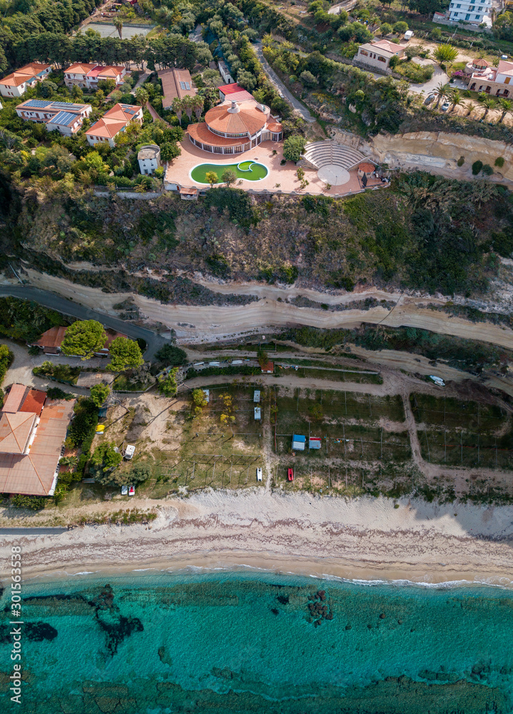 Obraz premium Aerial view of the Calabrian coast, villas and resorts on the cliff. Transparent sea and wild coast. Locality of Riaci near Tropea, Calabria. Italy