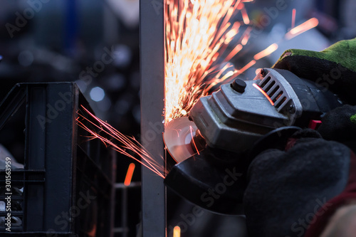 Worker cutting metal in the garage