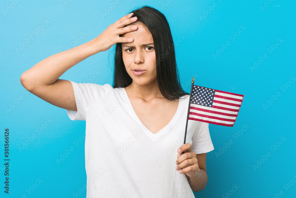 Young hispanic woman holding a united states flag being shocked, she has remembered important meeting. Young hispanic woman holding a united states flag being shocked, she has remembered important meeting.