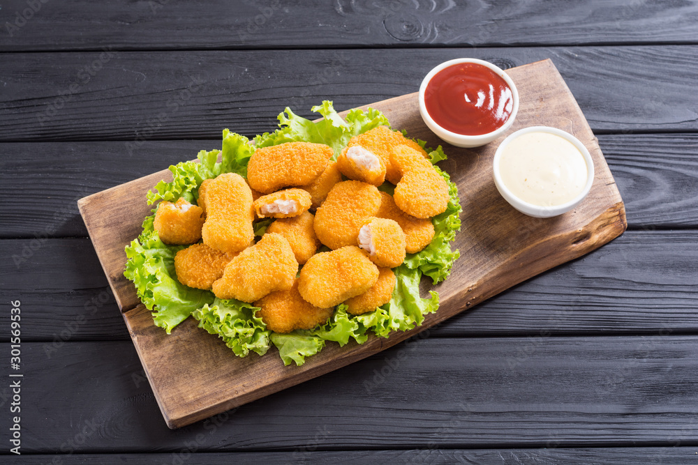 Chicken nuggets in plate on rustic background Chicken nuggets in plate on rustic background